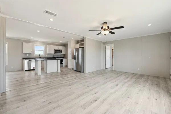 a view of kitchen with a sink a refrigerator and a chandelier