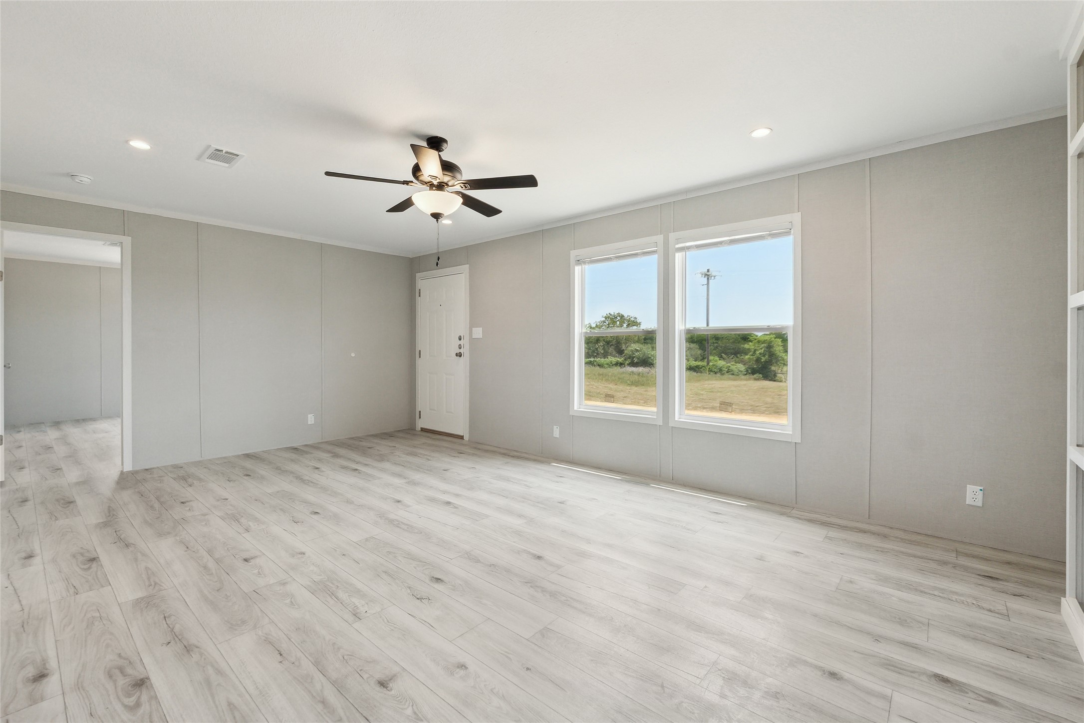 1287 Cr 402 Roads, Unit LOT 17 Flatonia, TX 78941 - Photo 13 of 37 Empty room featuring ceiling fan, crown molding, light wood-type flooring, and recessed lighting