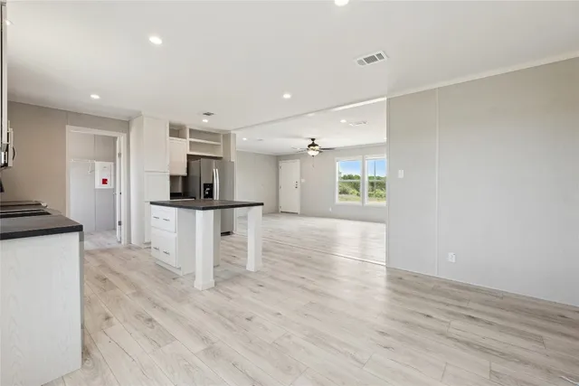 a view of kitchen with cabinets and wooden floor