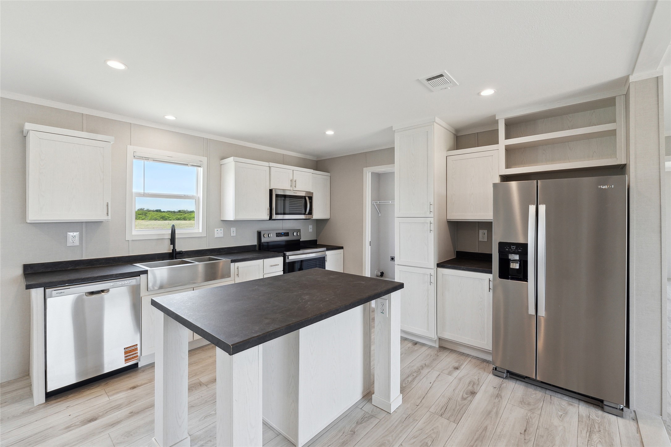 1287 Cr 402 Roads, Unit LOT 17 Flatonia, TX 78941 - Photo 22 of 37 Kitchen with appliances with stainless steel finishes, a sink, dark countertops, crown molding, and white cabinetry