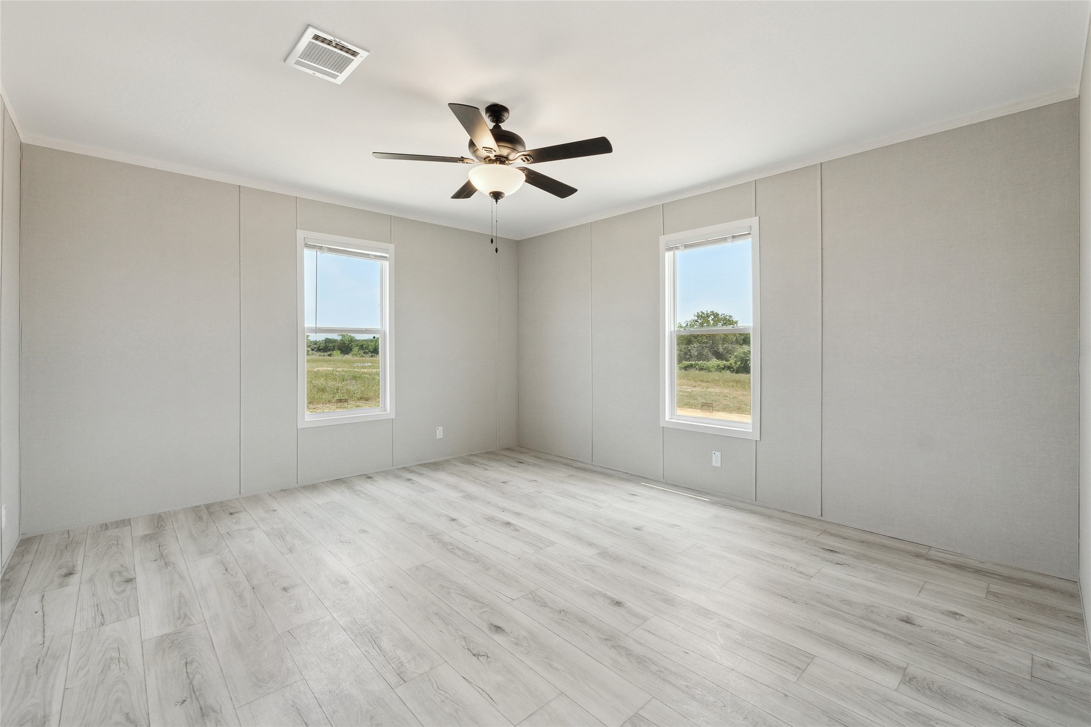 1287 Cr 402 Roads, Unit LOT 17 Flatonia, TX 78941 - Photo 24 of 37 Empty room featuring healthy amount of natural light, ceiling fan, light wood-style floors, and crown molding