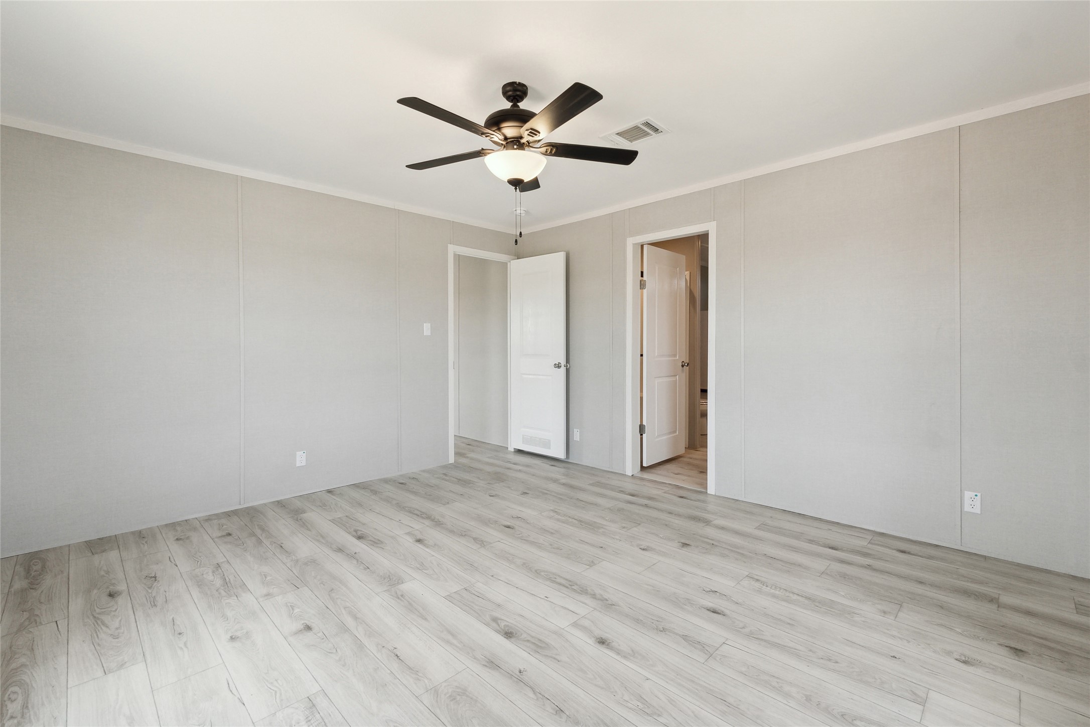 1287 Cr 402 Roads, Unit LOT 17 Flatonia, TX 78941 - Photo 26 of 37 Spare room featuring ornamental molding, light wood-style floors, and ceiling fan
