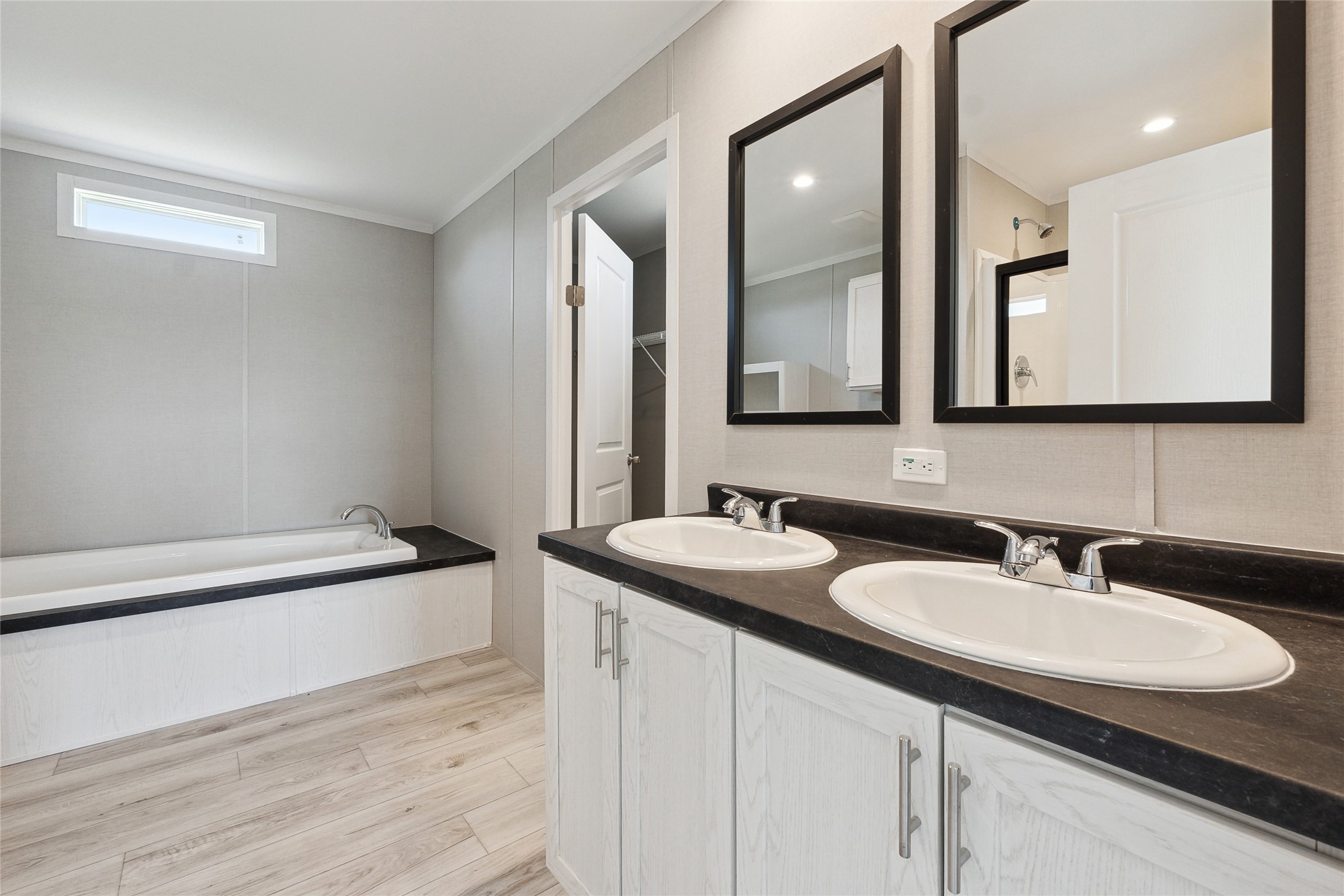 1287 Cr 402 Roads, Unit LOT 17 Flatonia, TX 78941 - Photo 27 of 37 Bathroom featuring double vanity, a garden tub, wood finished floors, and ornamental molding