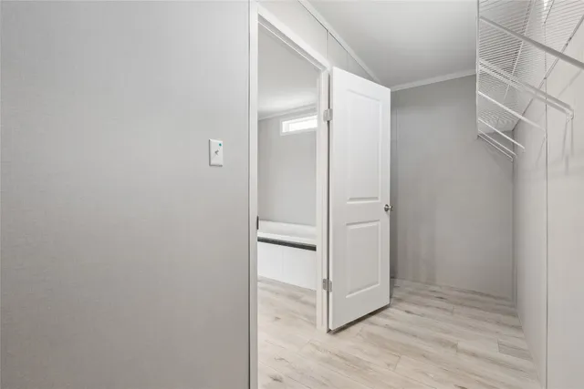 a view of walk in closet with empty racks