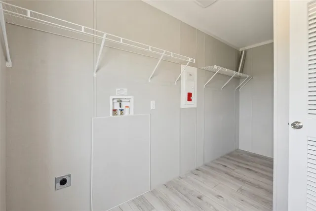 a view of walk in closet with empty racks