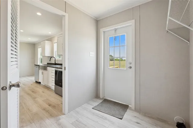 a view of kitchen with refrigerator and window