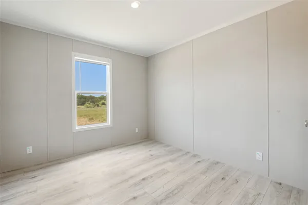 a view of an empty room and wooden floor