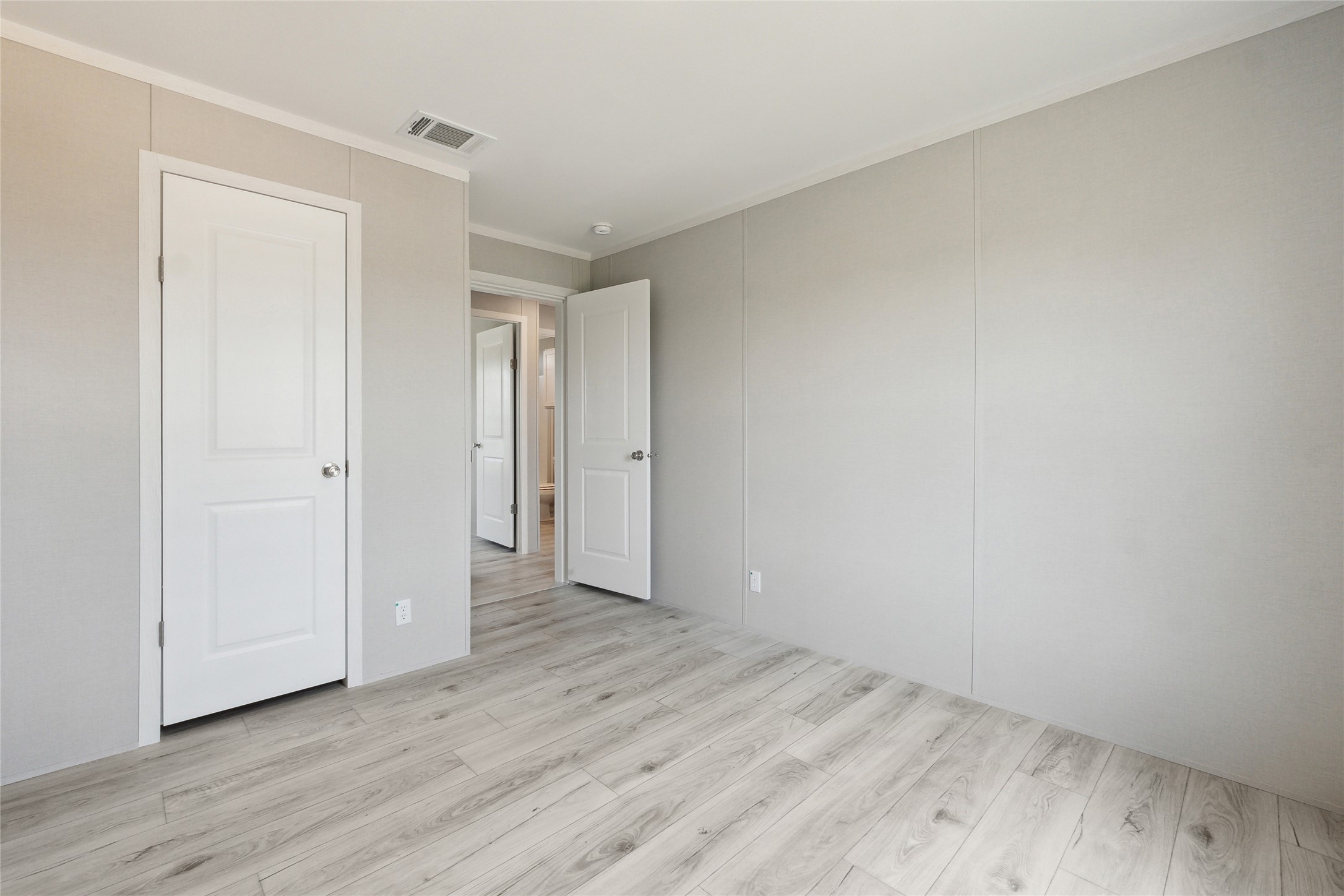 1287 Cr 402 Roads, Unit LOT 17 Flatonia, TX 78941 - Photo 36 of 37 Unfurnished bedroom with light wood-type flooring and ornamental molding
