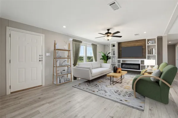 a living room with furniture and a flat screen tv