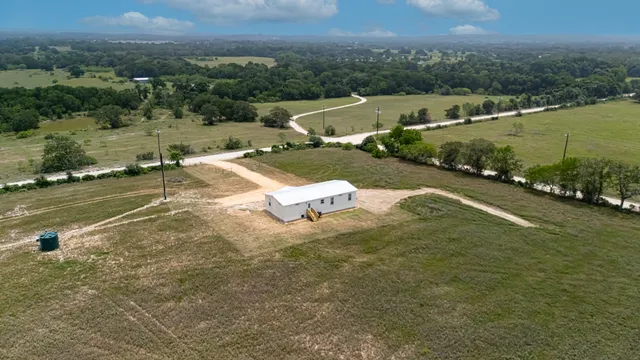 an aerial view of a house with a yard