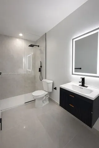 a bathroom with a toilet a sink a mirror and a bathtub