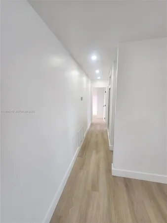 a spacious bathroom with a bathtub sink mirror and toilet