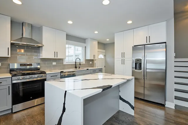 a kitchen with a stove sink and refrigerator
