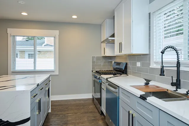 a kitchen with a sink stove and cabinets