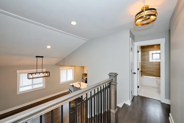 a view of entryway and hall with wooden floor