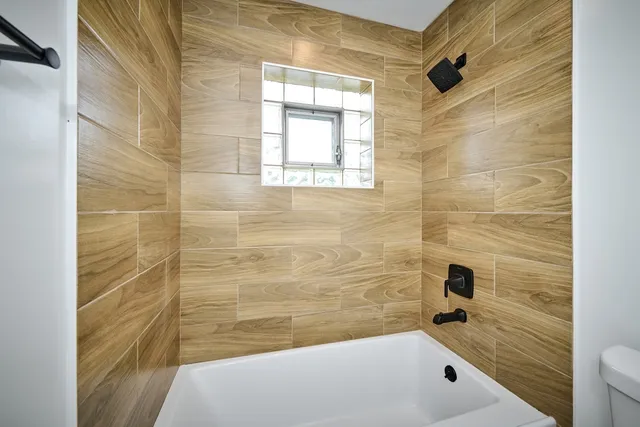 a bathroom with a bathtub and shower