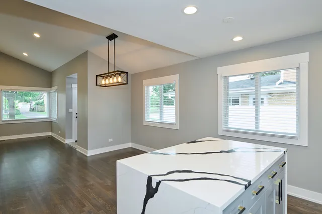 a view of a room that has a bed and a window