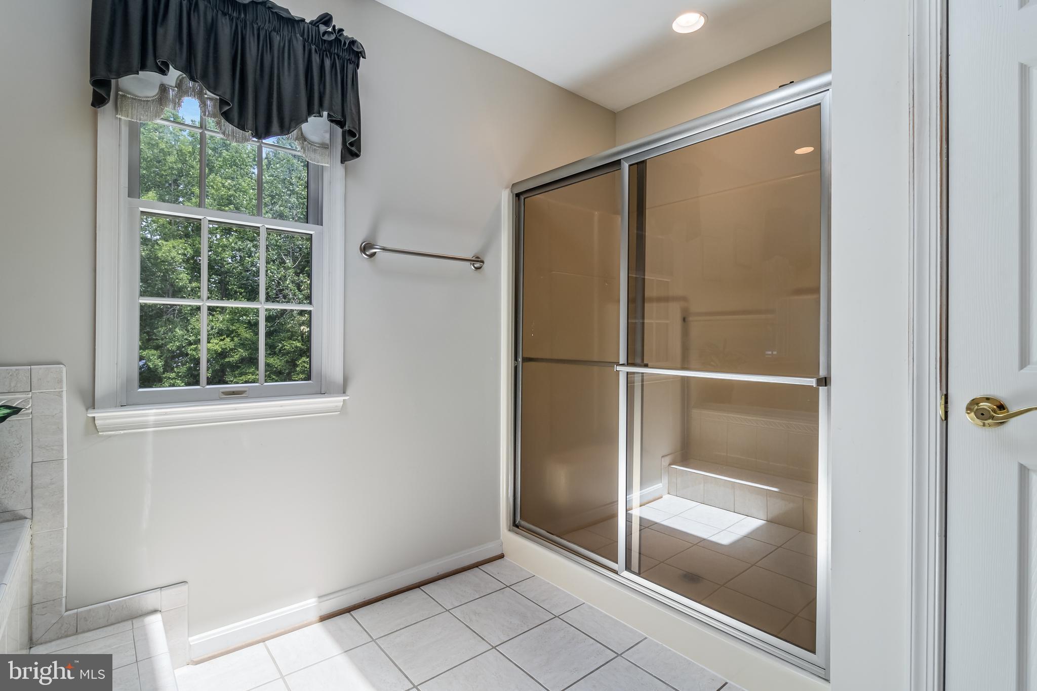 203 Morgans Ridge Court La Plata, MD 20646 - Photo 42 of 59 a bathroom with a glass shower door