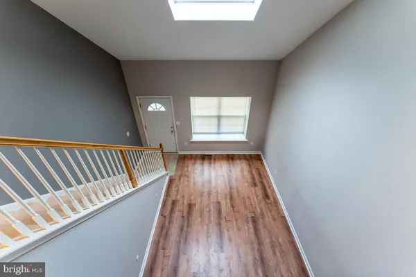 a view of wooden floor in a hallway
