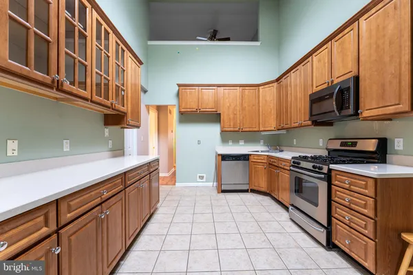 a kitchen with stainless steel appliances granite countertop a sink and cabinets