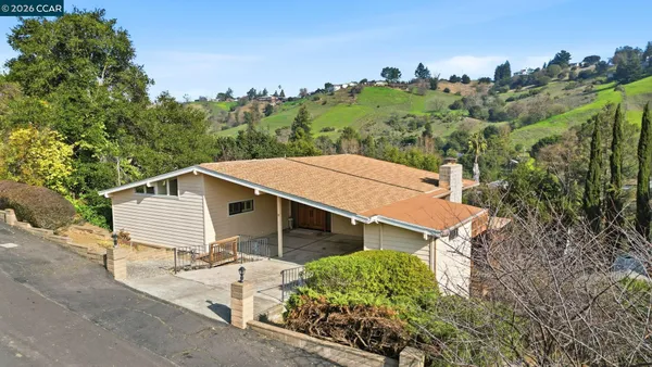 an aerial view of a house with a yard