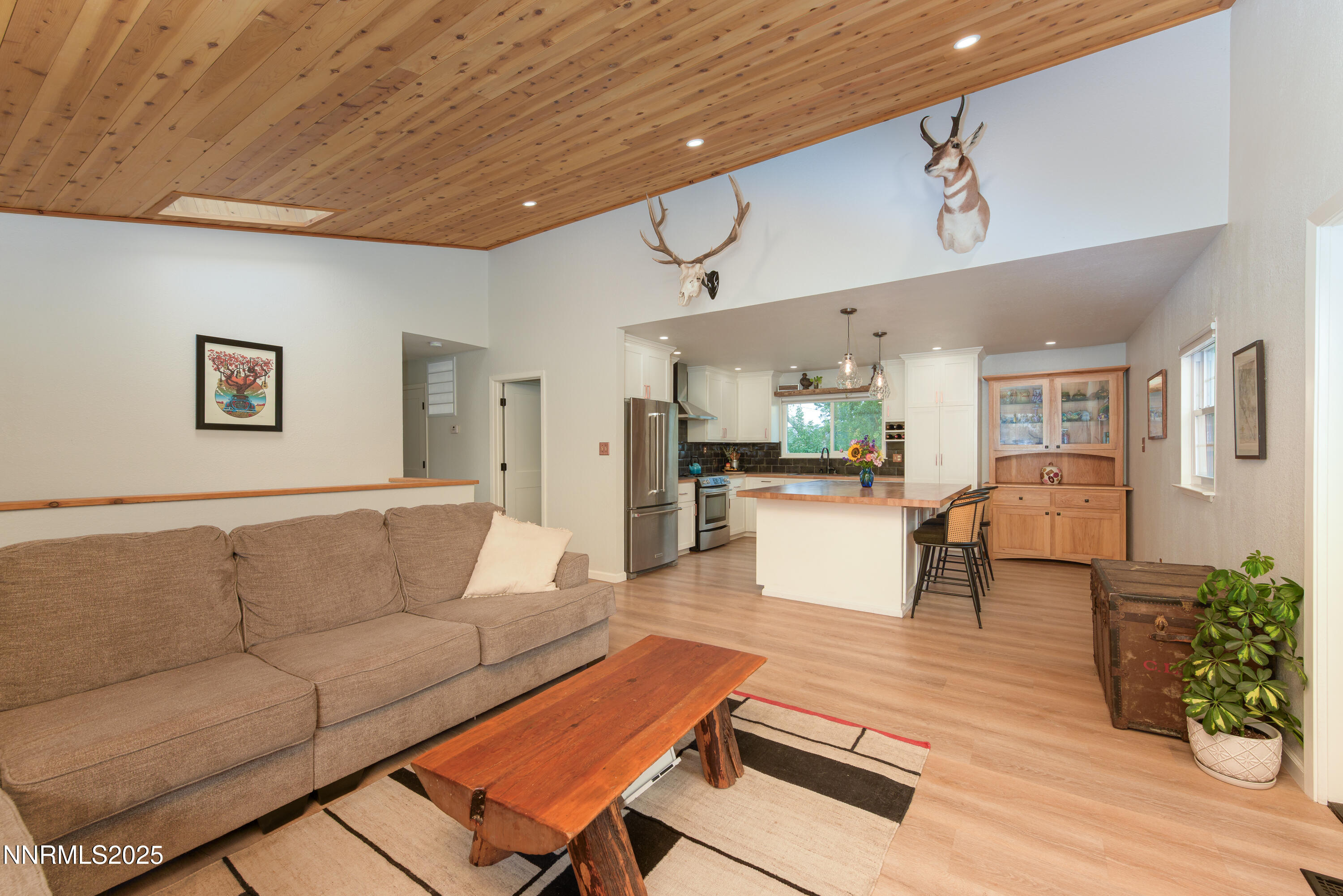 a living room with furniture and kitchen view