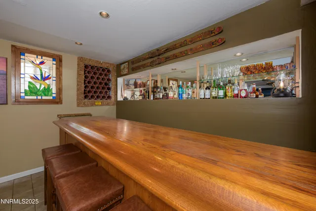 a view of room with window and painting on the wall