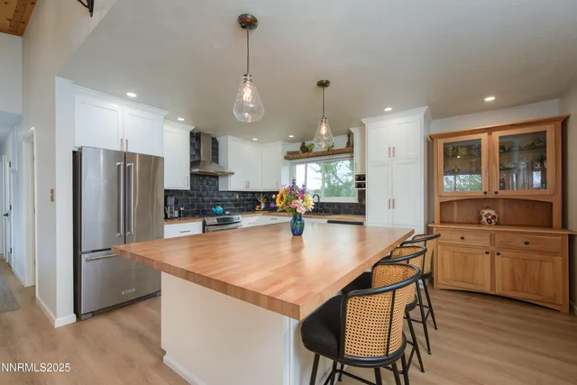 a kitchen with stainless steel appliances granite countertop counter space a sink refrigerator and cabinets