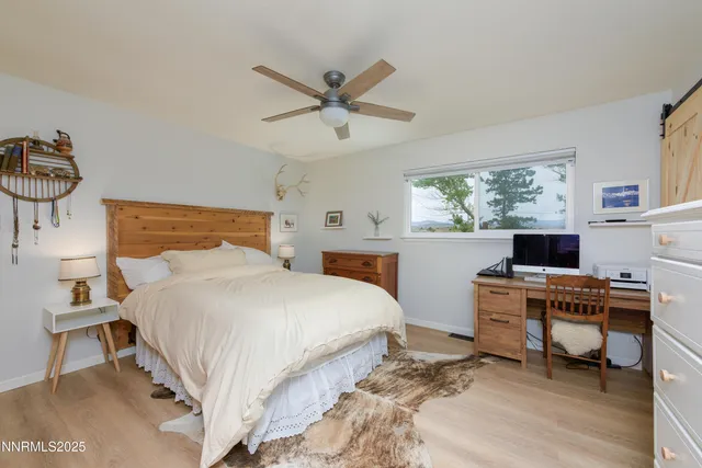 a bedroom with a bed and a desk