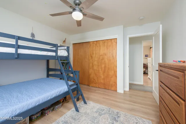 a room with furniture and a chandelier fan