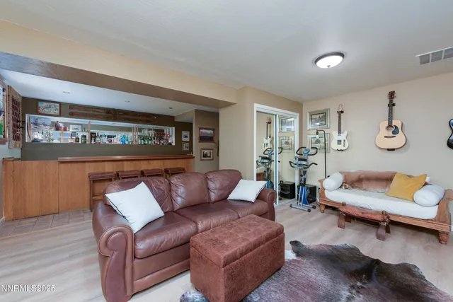 a living room with furniture and painting on the wall