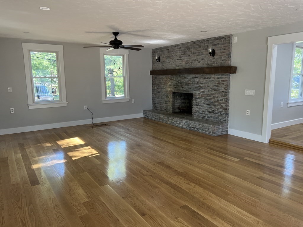 138 High Street Hingham, MA 02043 - Photo 7 of 23 an empty room with windows and fireplace