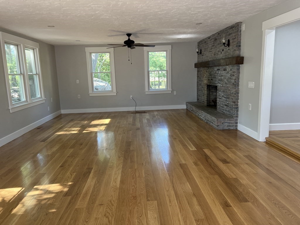 138 High Street Hingham, MA 02043 - Photo 8 of 23 a view of an empty room with wooden floor fireplace and a window