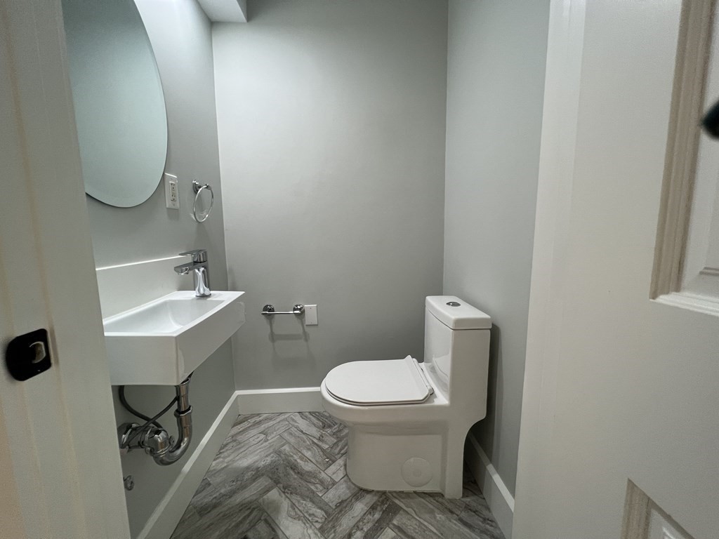 138 High Street Hingham, MA 02043 - Photo 10 of 23 a white toilet sitting next to a bathroom sink