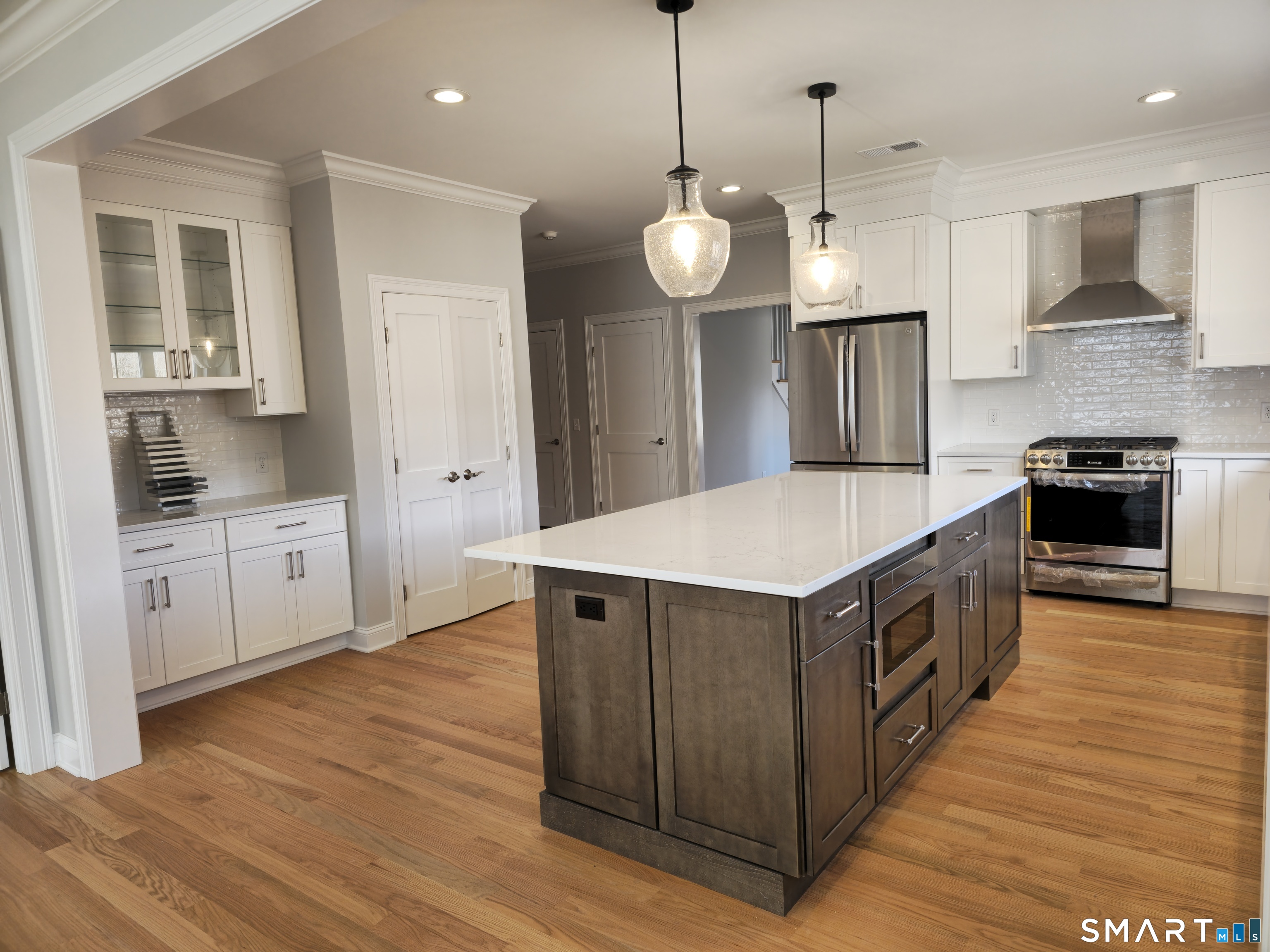 151-153 East Main Street, Unit 23 Clinton, CT 06413 - Photo 10 of 33 a kitchen with a stove and wooden floor