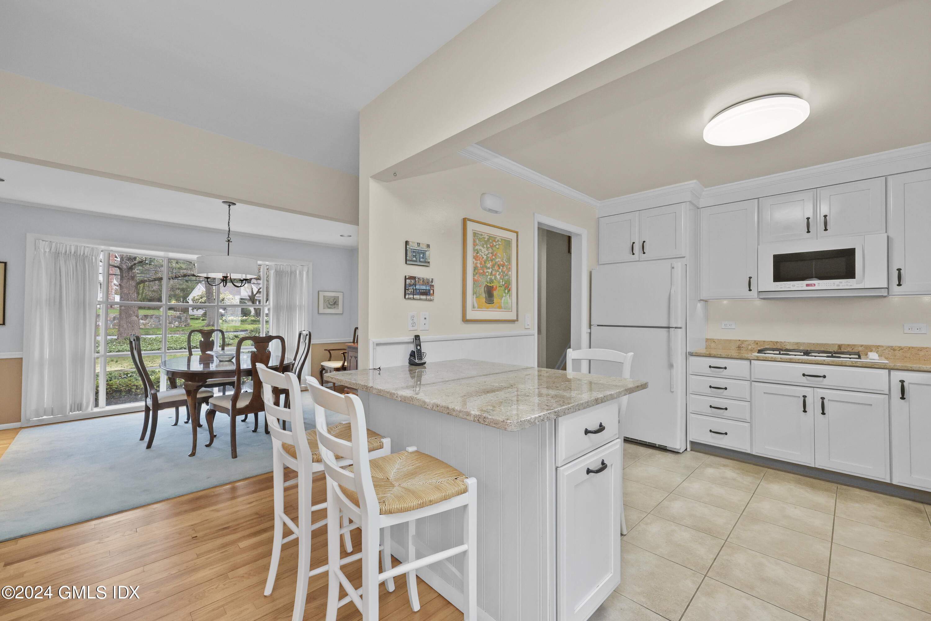28 Dandy Drive Cos Cob, CT 06807 - Photo 6 of 24 a kitchen with appliances cabinets dining table and chairs