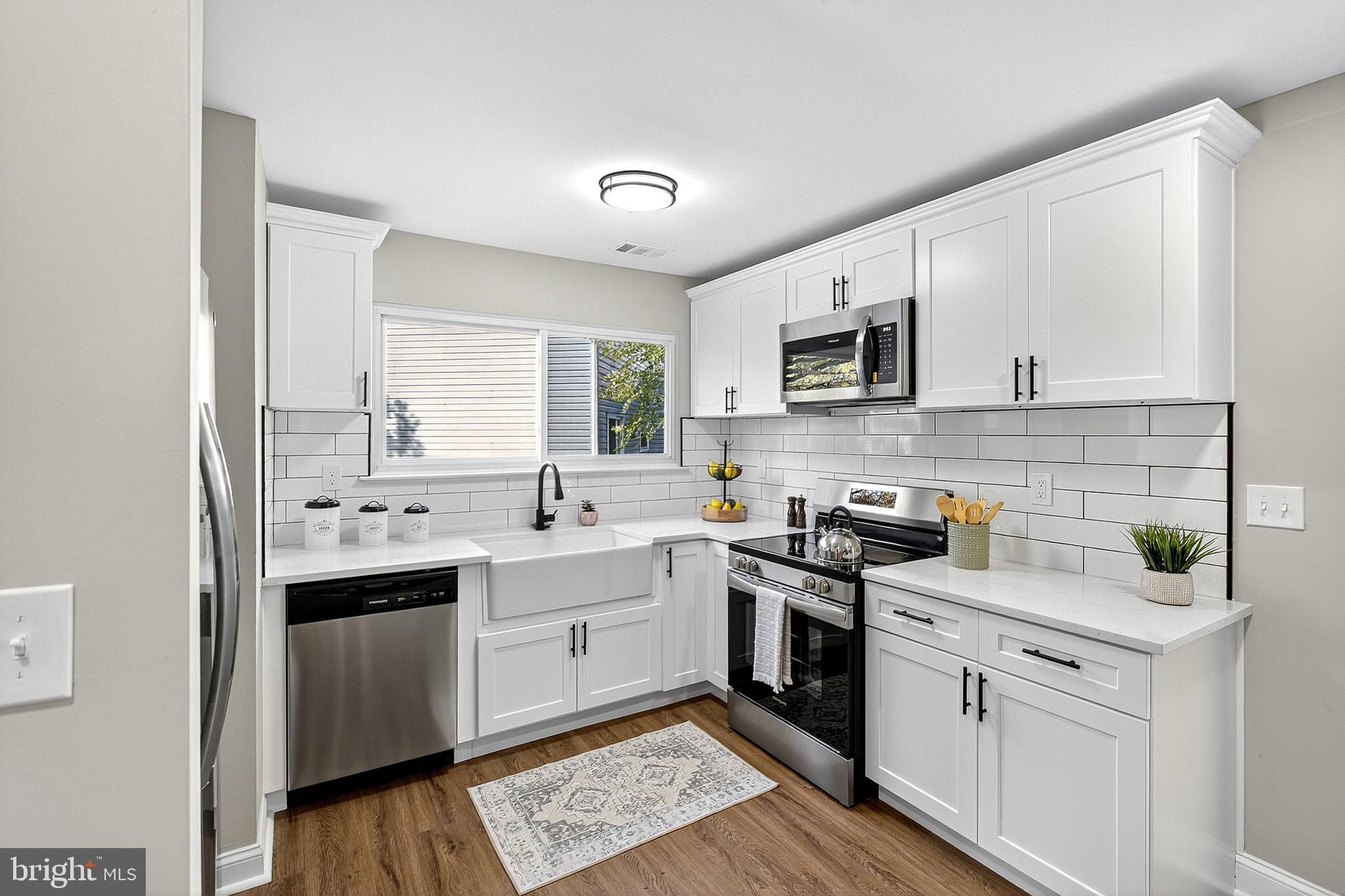 4 Corvas Court Sewell, NJ 08080 - Photo 18 of 40 a kitchen with a sink stove and cabinets