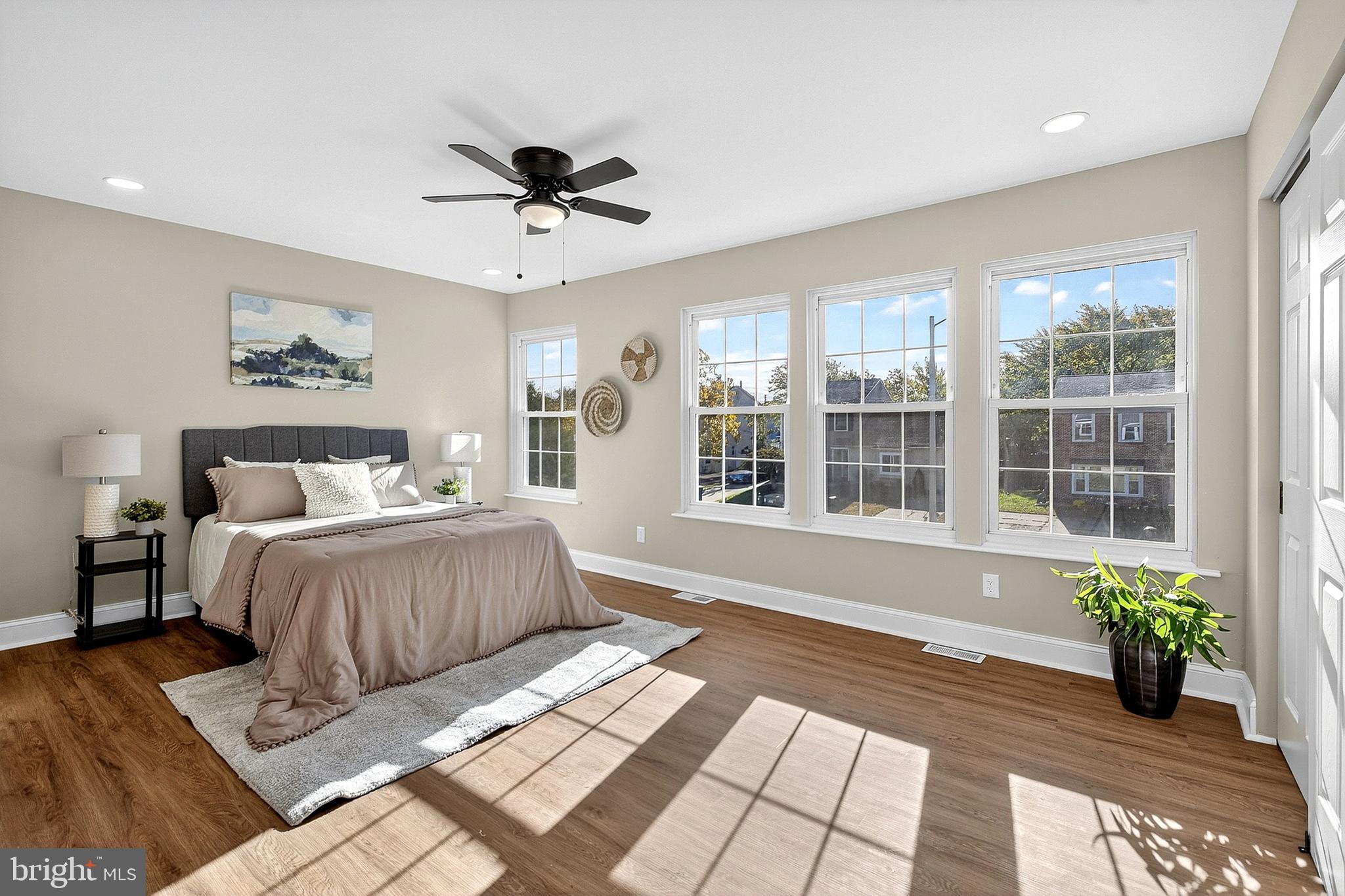 4 Corvas Court Sewell, NJ 08080 - Photo 32 of 40 a spacious bedroom with a large bed a chandelier and windows