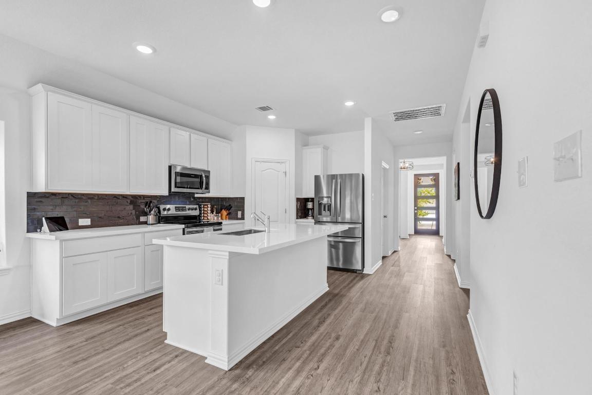 1321 Morning View Road Georgetown, TX 78628 - Photo 1 of 1 a kitchen with stainless steel appliances a refrigerator sink and white cabinets