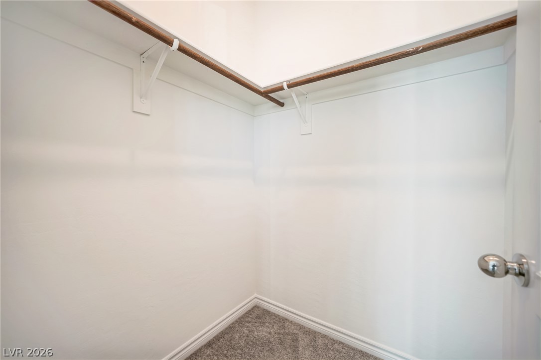 7348 North Decatur Boulevard, Unit 1 North Las Vegas, NV 89084 - Photo 8 of 17 Ample hanging space and soft carpet define this functional walk-in closet.
