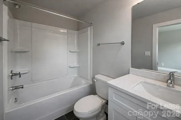 a bathroom with a sink toilet vanity and shower