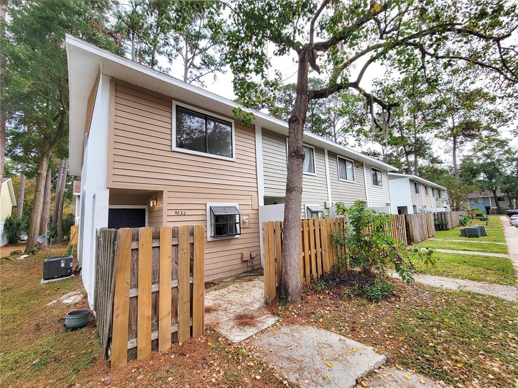 4032 Southwest 21st Lane Gainesville, FL 32607 - Photo 1 of 1 a view of a house with a yard