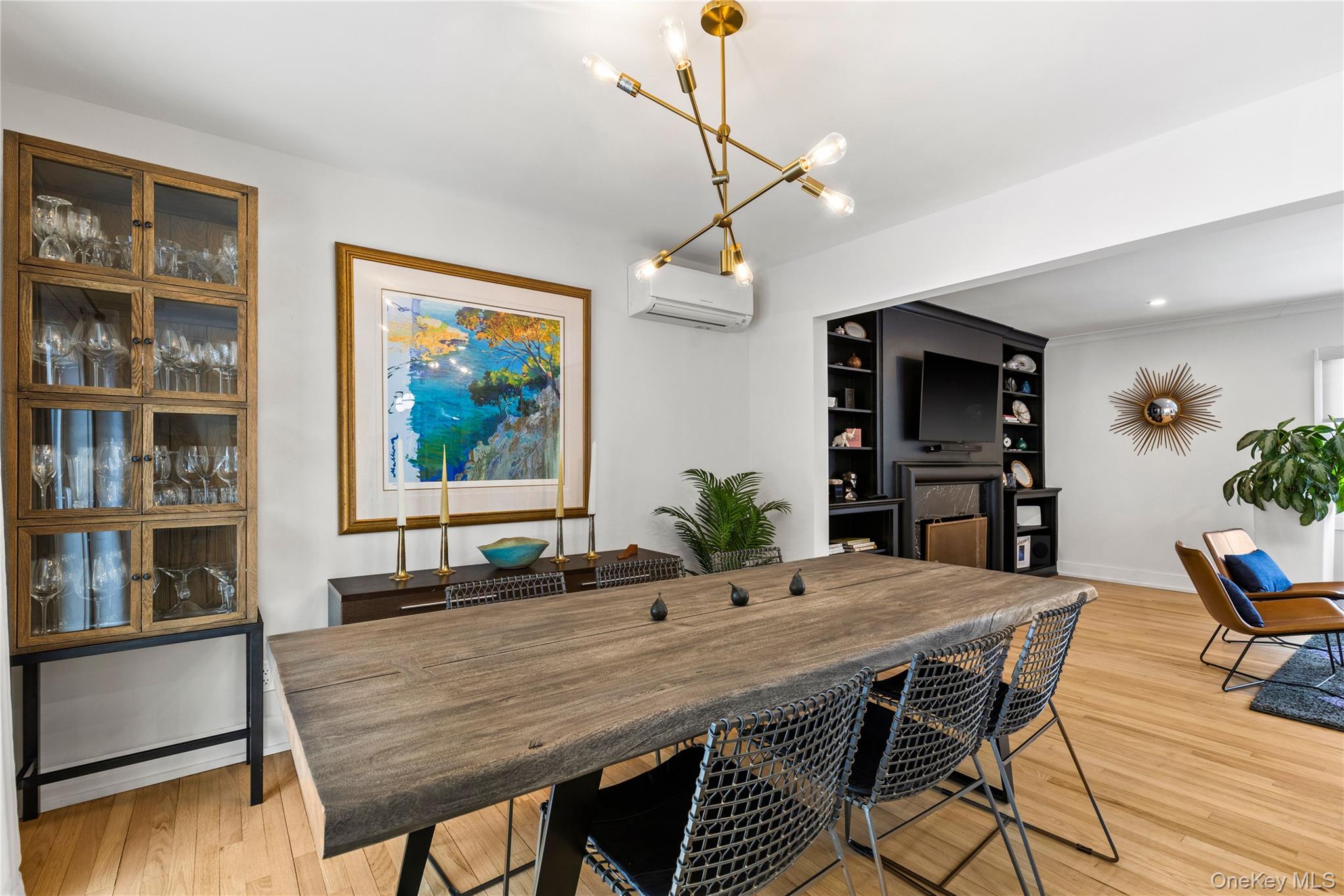 24 Old Well Road Purchase, NY 10577 - Photo 13 of 37 a dining room with furniture potted plants and wooden floor