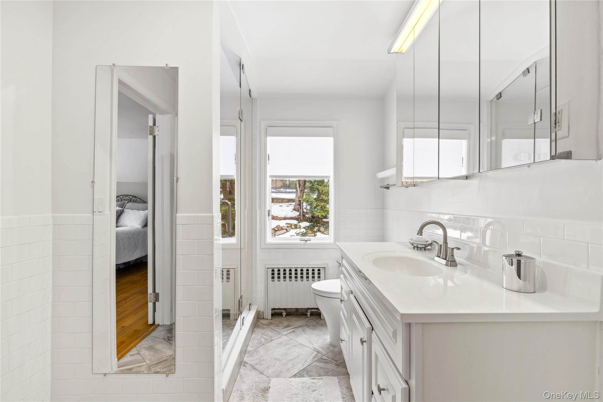 24 Old Well Road Purchase, NY 10577 - Photo 19 of 37 a bathroom with a sink a vanity and a mirror