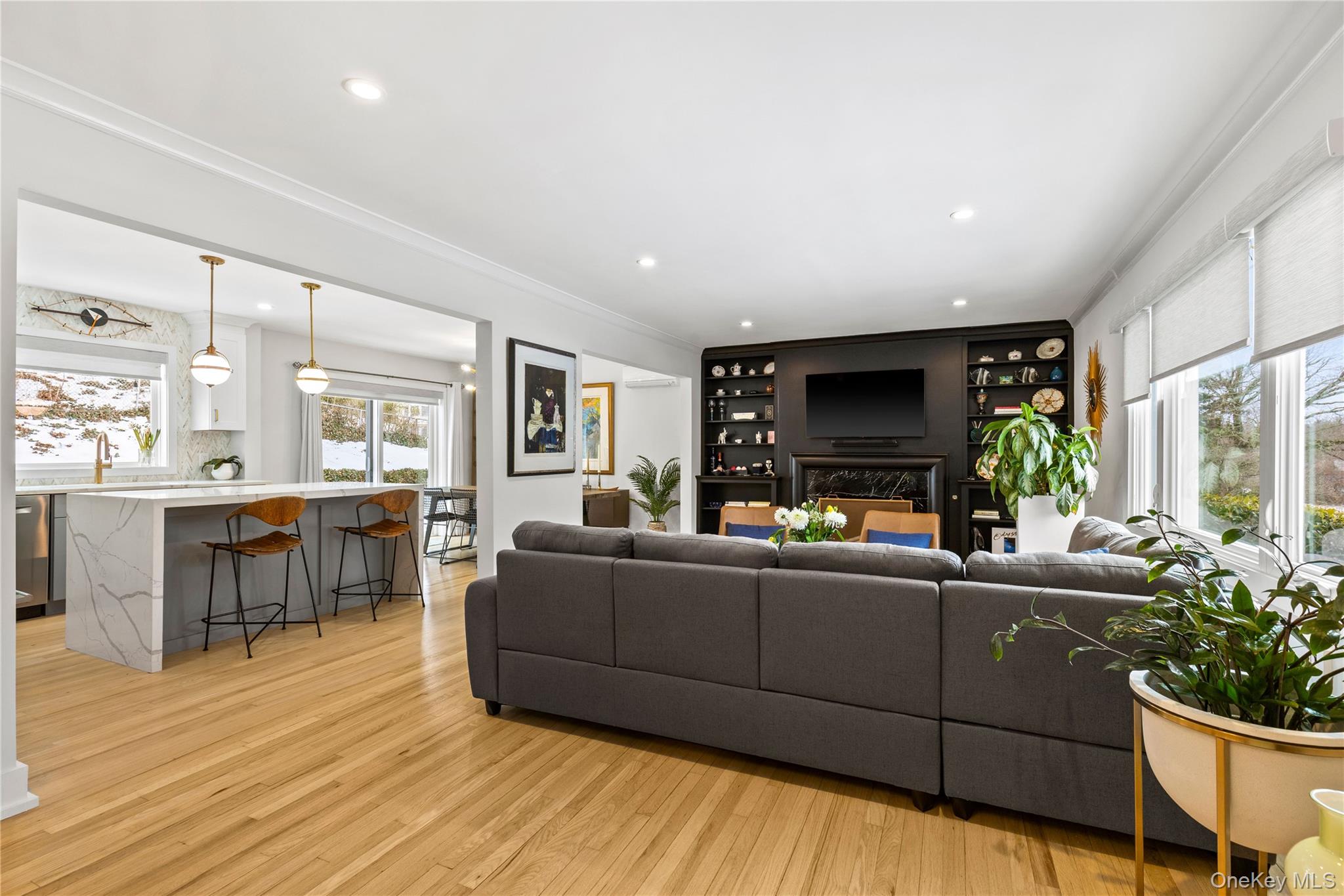 24 Old Well Road Purchase, NY 10577 - Photo 2 of 37 a living room with furniture a flat screen tv and a floor to ceiling window
