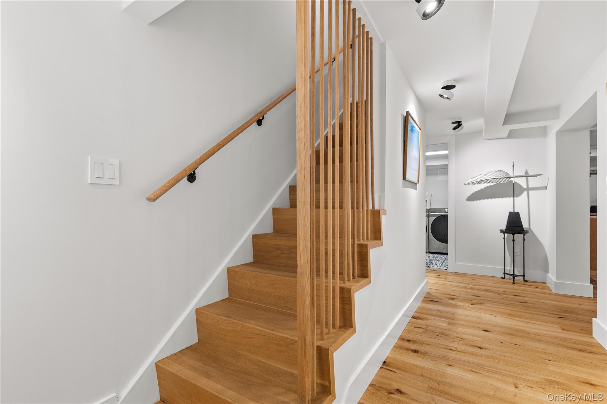 24 Old Well Road Purchase, NY 10577 - Photo 23 of 37 a view of a hallway with wooden floor and staircase