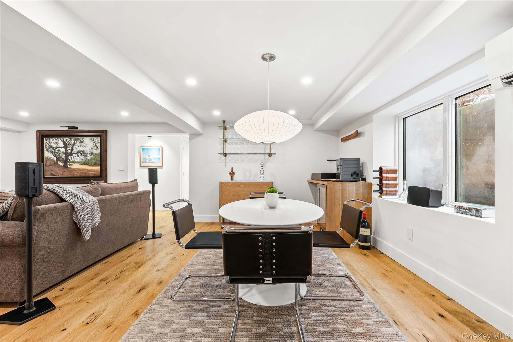 24 Old Well Road Purchase, NY 10577 - Photo 27 of 37 a large room with kitchen island a wooden floor and white walls