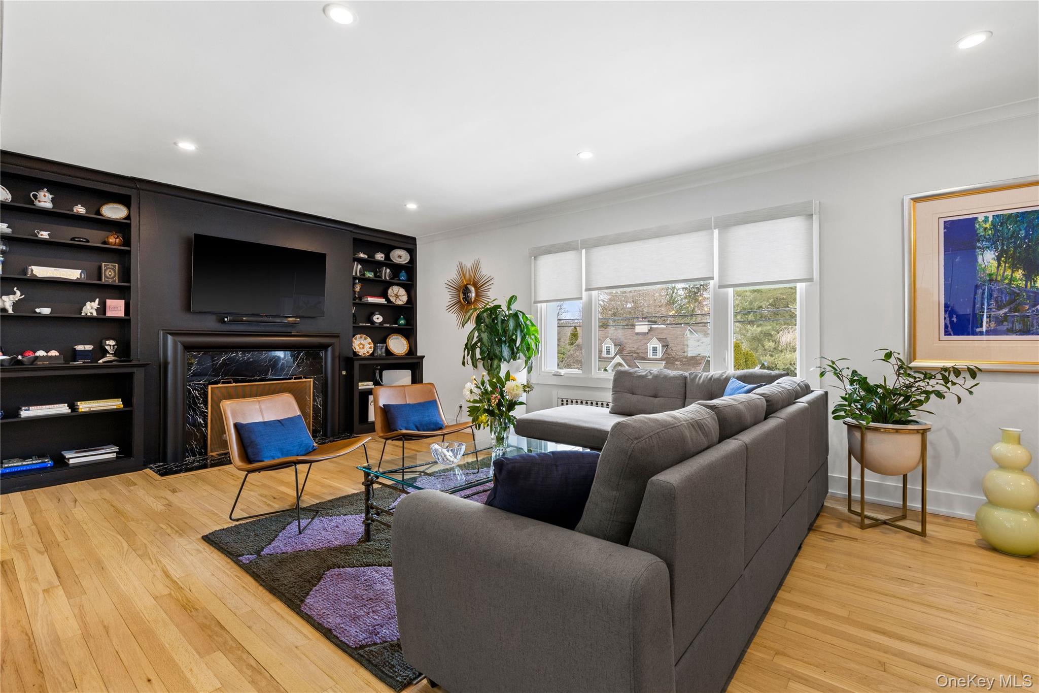 24 Old Well Road Purchase, NY 10577 - Photo 3 of 37 a living room with furniture a flat screen tv and a fireplace