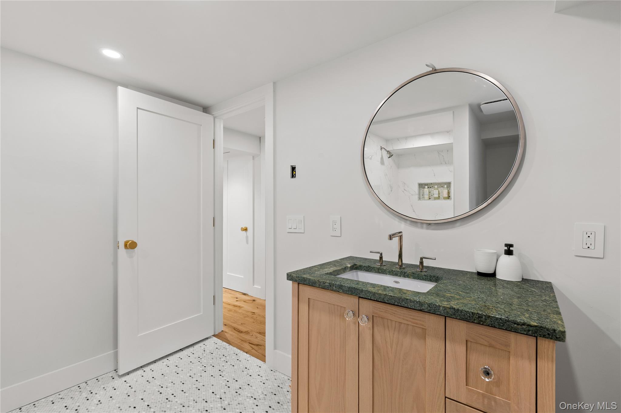 24 Old Well Road Purchase, NY 10577 - Photo 31 of 37 a bathroom with a granite countertop sink a mirror and a shower