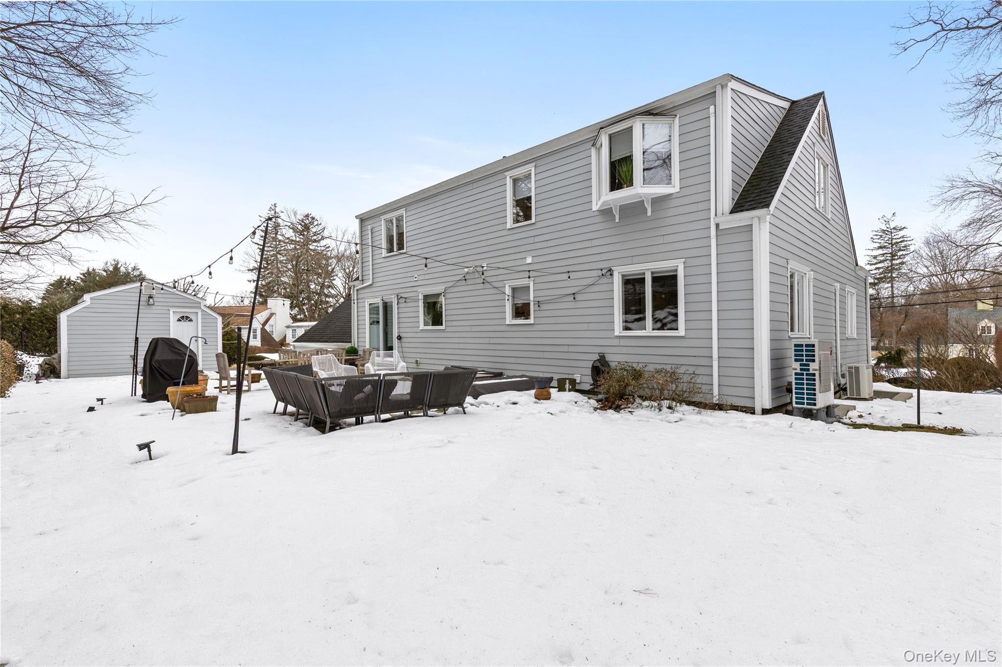 24 Old Well Road Purchase, NY 10577 - Photo 33 of 37 a view of a house with snow on the side of road